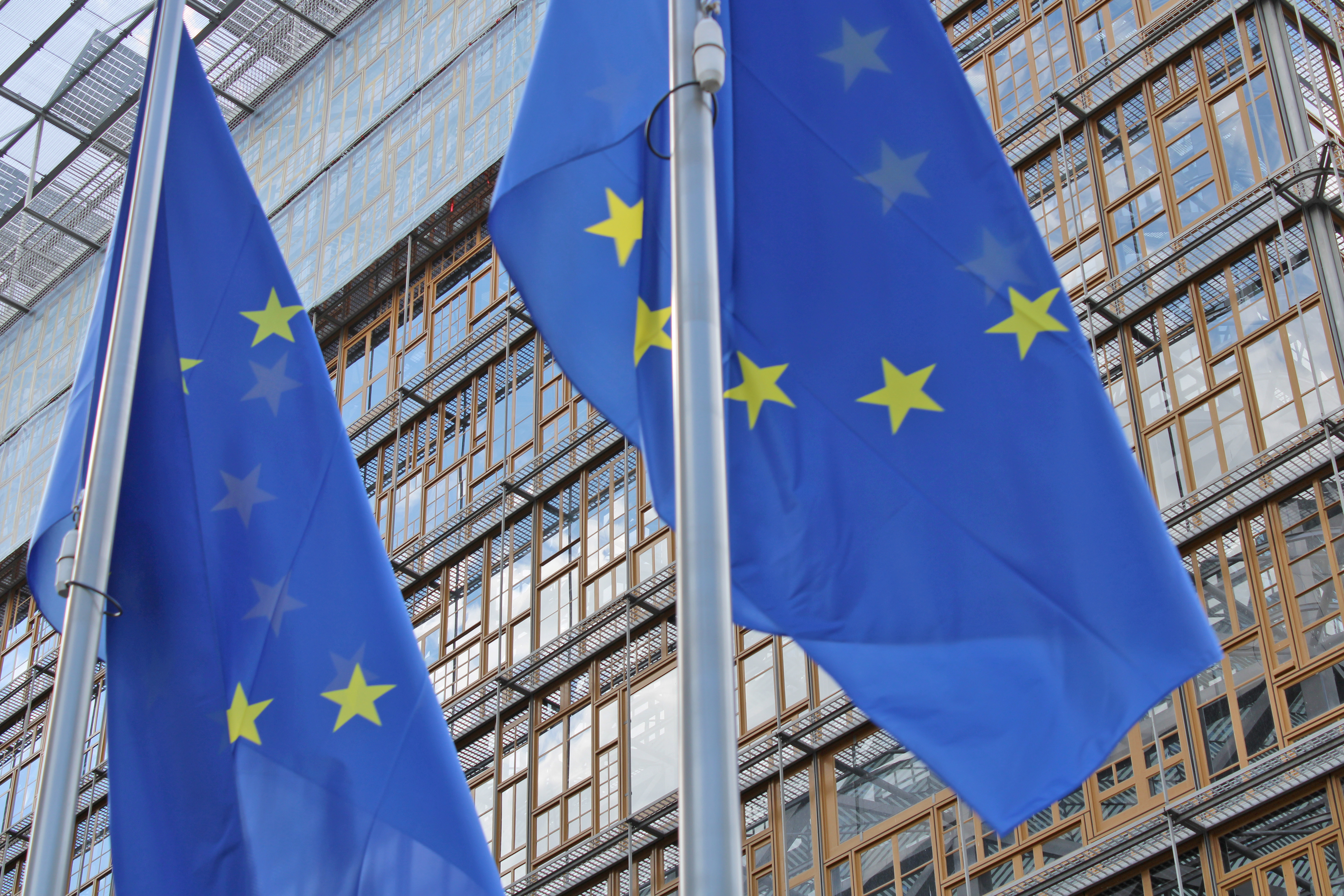 Decorative photo of the EU institutions headquarters in Brussels, place Schuman. It shows EU flags in front of Europa building on a sunny day in September 2026